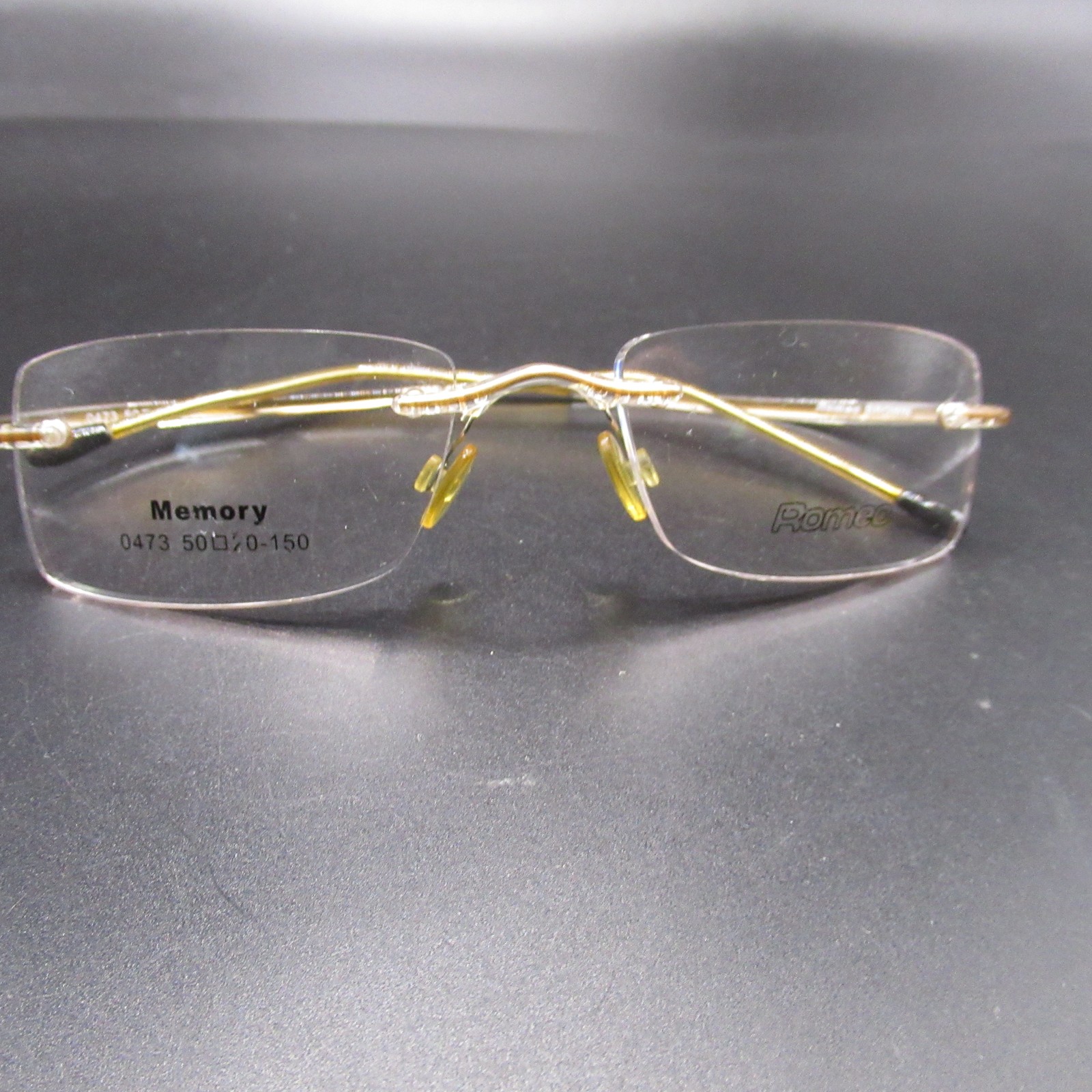 Romeo Memory Rimless Eyeglass Frames Gold Tone 50-20-150 Brown Temples 0473